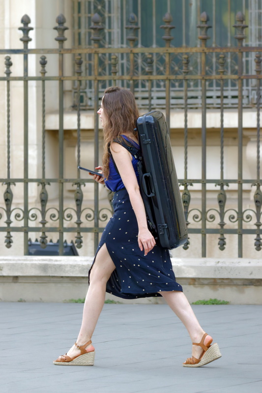 Young girl carrying a musical instrument
